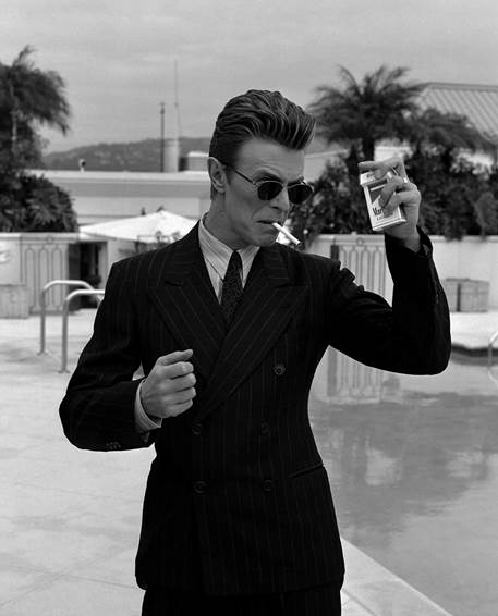 A person in a suit smoking a cigarette AI-generated content may be incorrect.